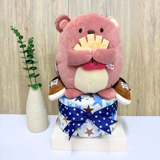 1-Tier Nomo Bear Diaper Cake with soft bear plush, swaddle blanket, shoes, and arranged diapers